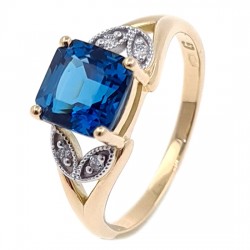 Złoty pierścionek z london blue topaz i  brylantami 